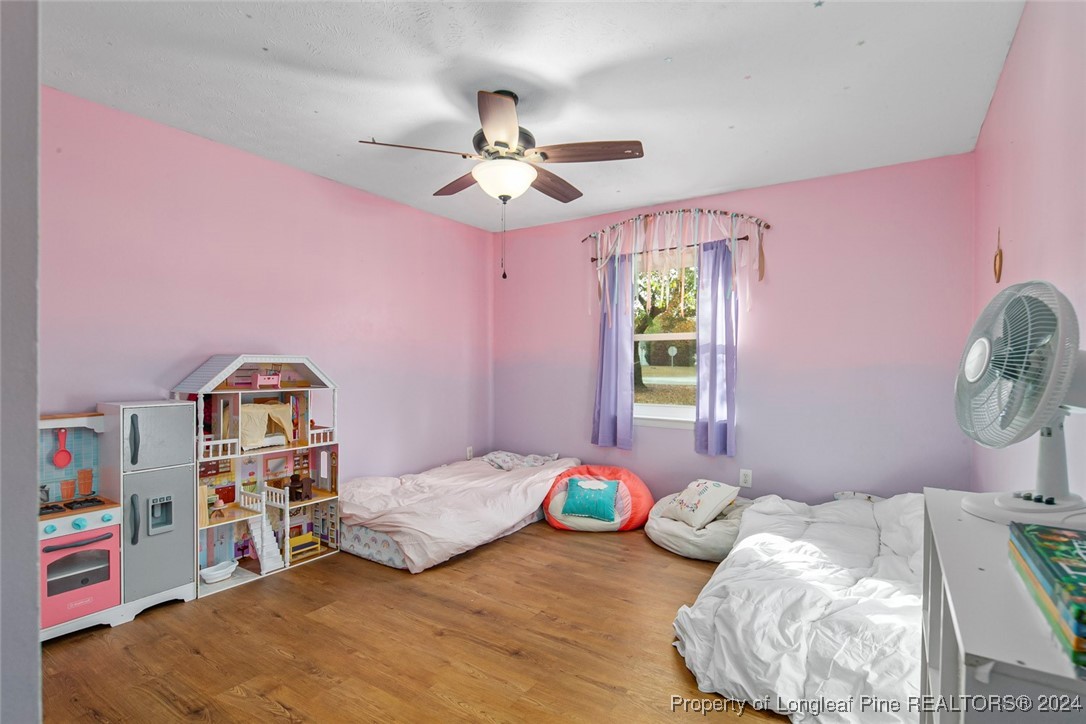 3009 Rouse Road Fayetteville, NC 28306 - Photo 22 of 37 a bedroom with a bed and a chandelier