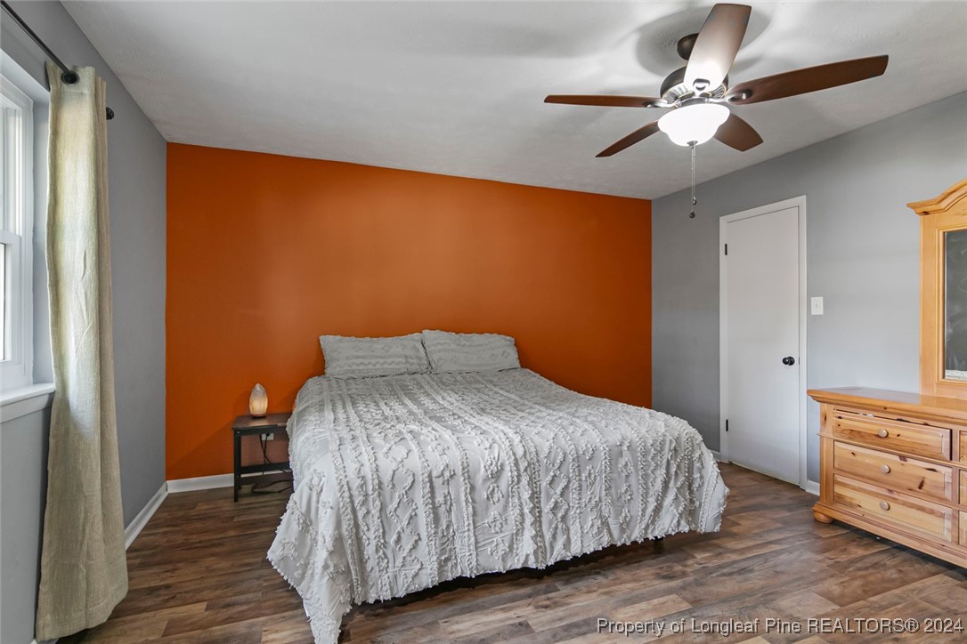 3009 Rouse Road Fayetteville, NC 28306 - Photo 28 of 37 a bedroom with a bed chandelier and a window