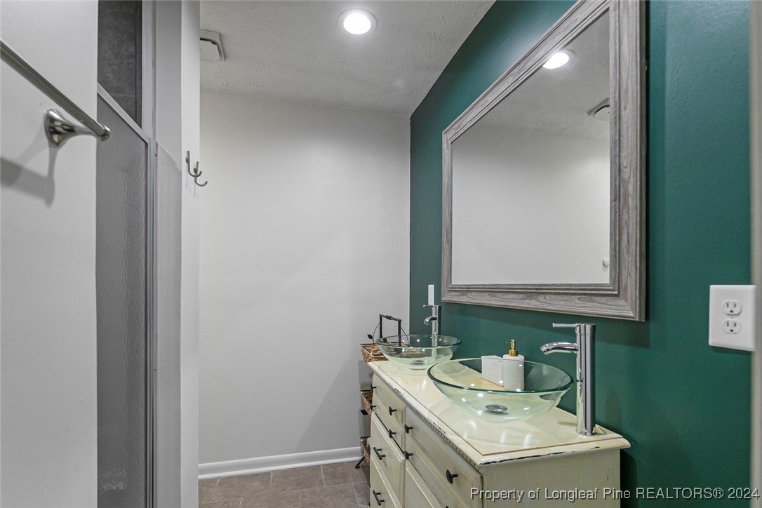 3009 Rouse Road Fayetteville, NC 28306 - Photo 29 of 37 a bathroom with a sink vanity and a mirror