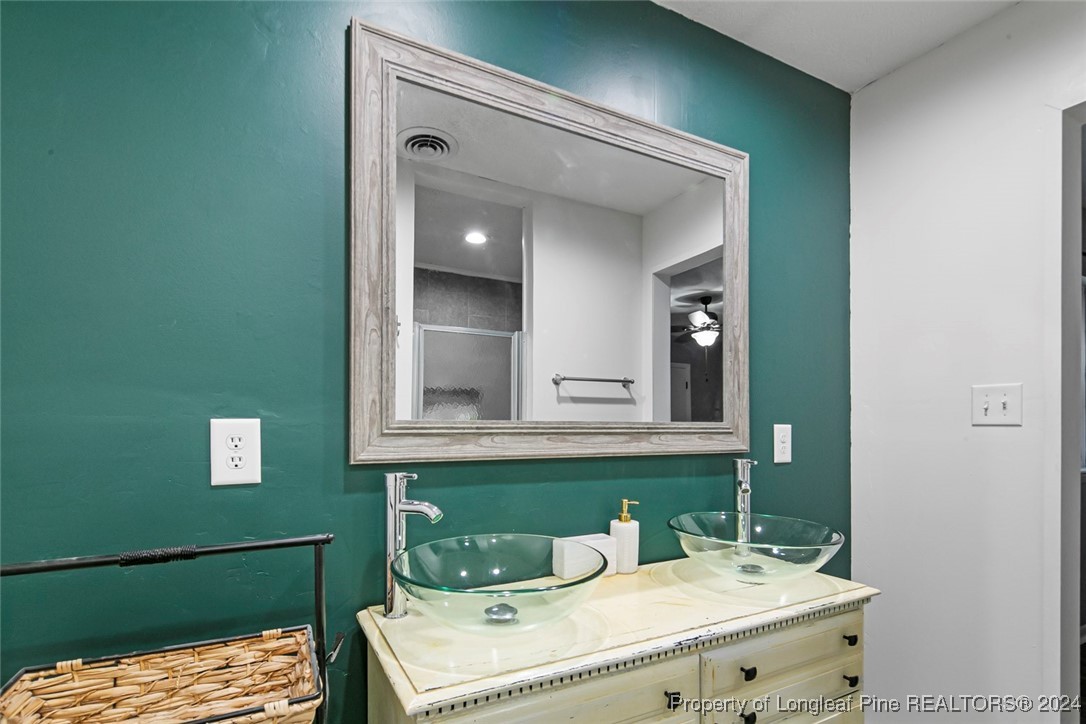 3009 Rouse Road Fayetteville, NC 28306 - Photo 32 of 37 a bathroom with a sink and a mirror
