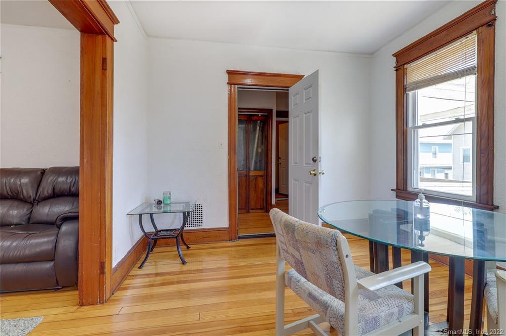 19 5th Street Ansonia, CT 06401 - Photo 11 of 38 a view of dining room and livingroom with furniture wooden floor and windows