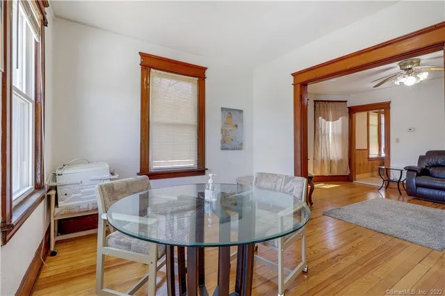 a dining room with furniture and wooden floor