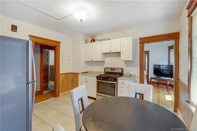 a kitchen with a stove a refrigerator and a sink