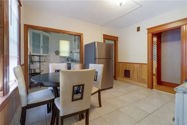 a dining room with furniture and window
