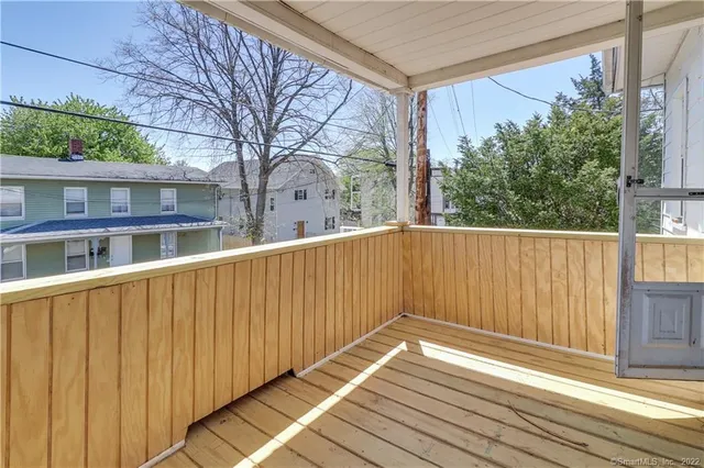 a view of wooden balcony with a trees