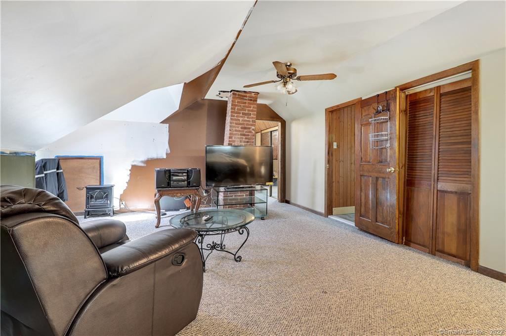 19 5th Street Ansonia, CT 06401 - Photo 25 of 38 a living room with furniture and a flat screen tv