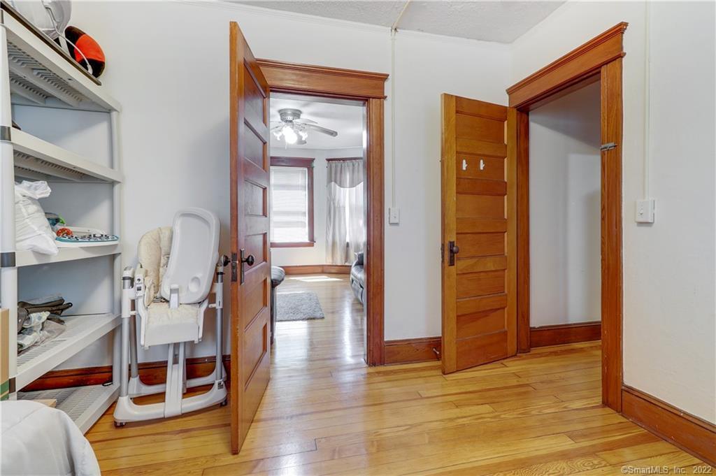 19 5th Street Ansonia, CT 06401 - Photo 27 of 38 a view of a bedroom with baby crib and dresser