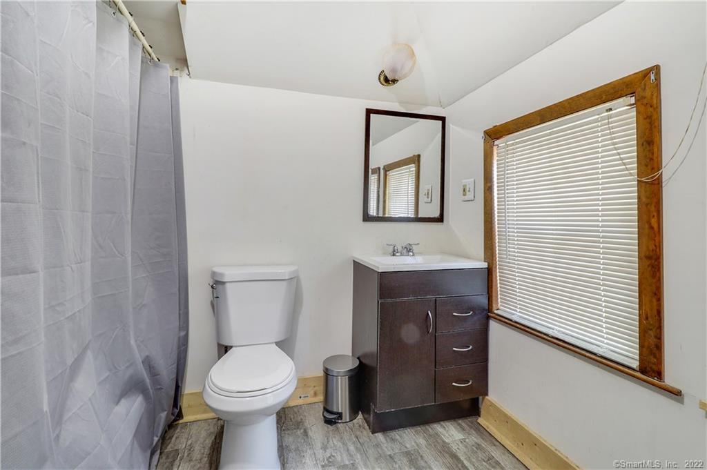 19 5th Street Ansonia, CT 06401 - Photo 28 of 38 a bathroom with a toilet a sink and mirror
