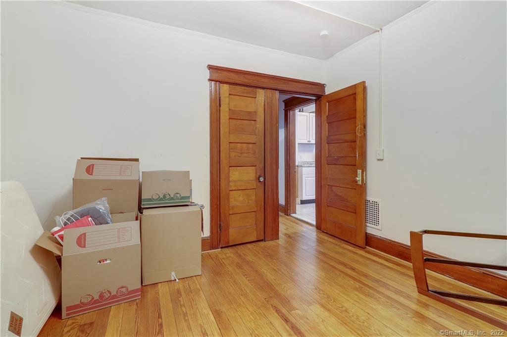 19 5th Street Ansonia, CT 06401 - Photo 35 of 38 a view of a room with wooden floor and closet