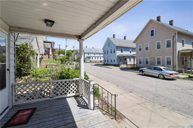 a city view with tall buildings and cars parked