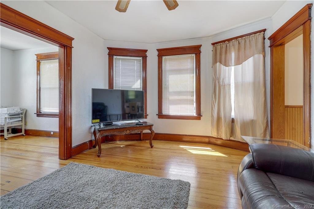 19 5th Street Ansonia, CT 06401 - Photo 8 of 38 a living room with furniture and a flat screen tv