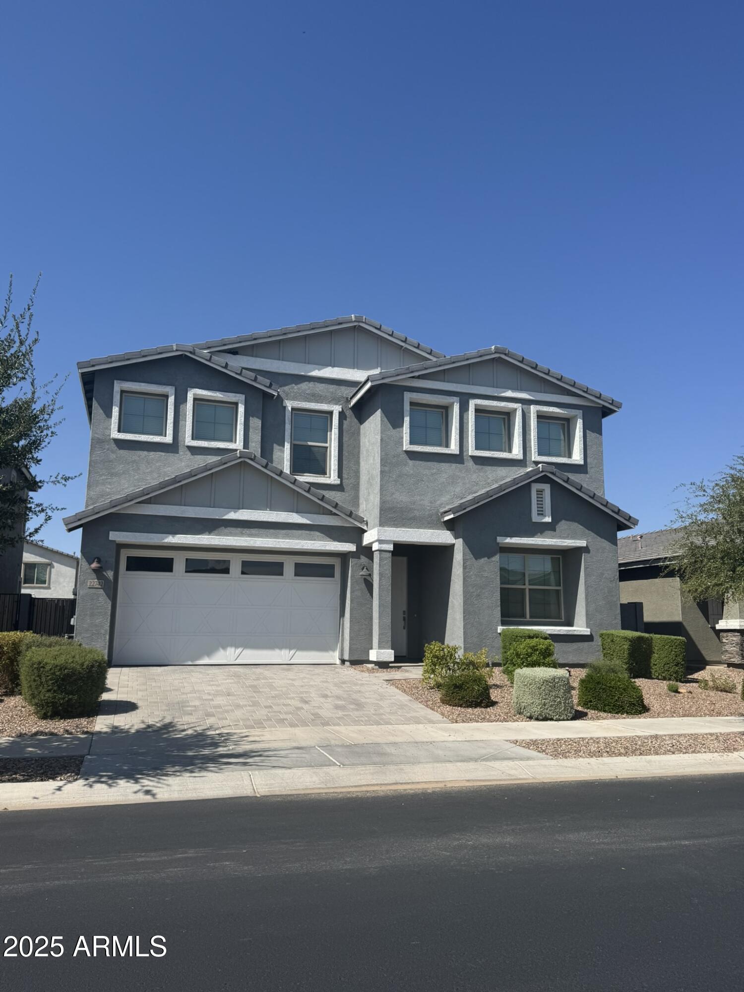 22742 East Domingo Road Queen Creek, AZ 85142 - Photo 1 of 23 a front view of a house with a yard and garage
