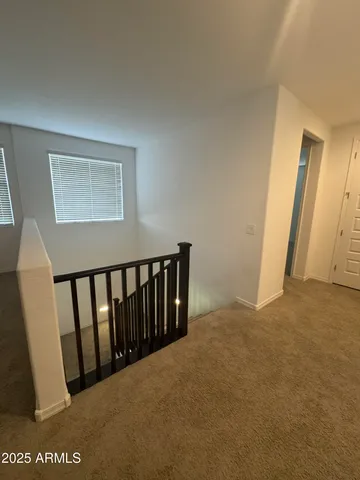 a view of a house with a big yard potted plants and large tree