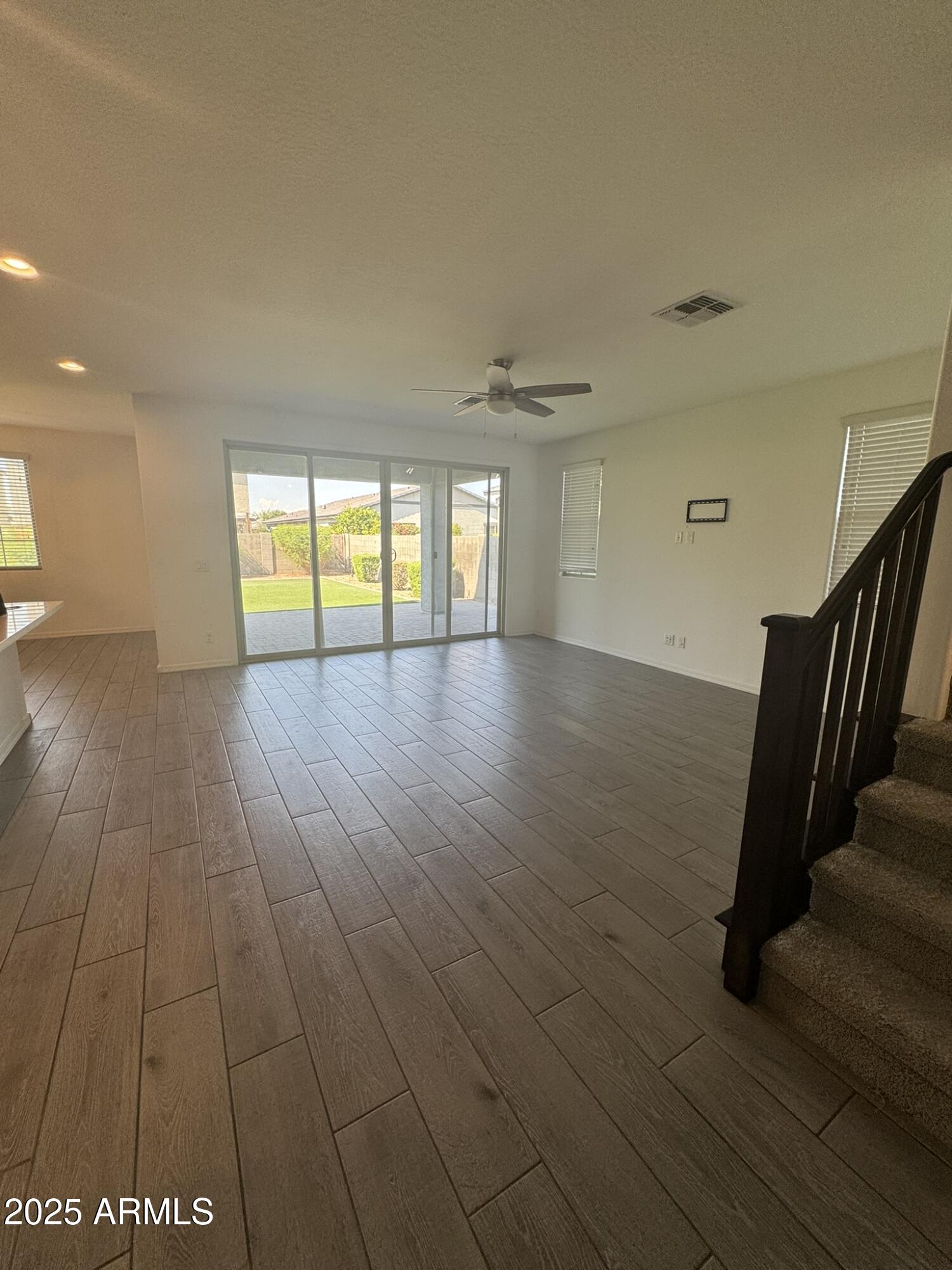 22742 East Domingo Road Queen Creek, AZ 85142 - Photo 18 of 23 a view of an empty room with wooden floor and a window