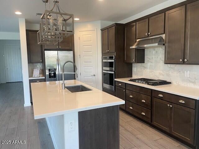 22742 East Domingo Road Queen Creek, AZ 85142 - Photo 22 of 23 a kitchen with stainless steel appliances a sink and a refrigerator
