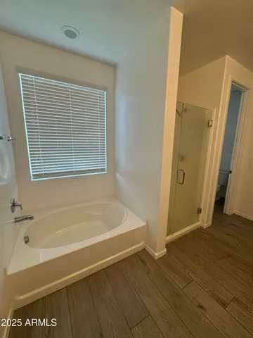 a bathroom with bathtub and a shower