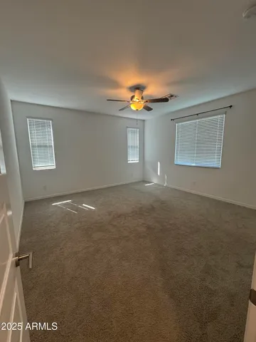 a view of empty room with window and fireplace