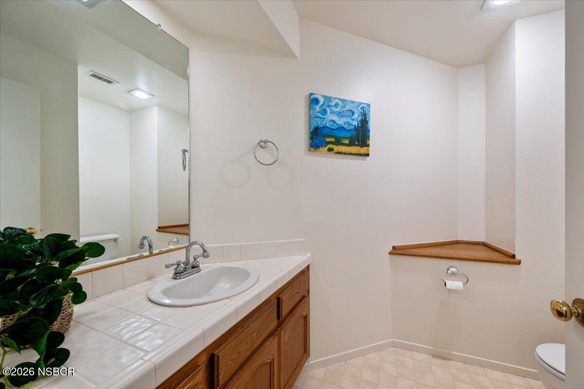 892 Onstott Road Lompoc, CA 93436 - Photo 25 of 40 a bathroom with a sink and a mirror