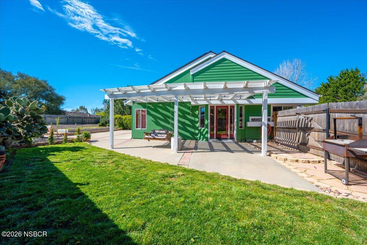 892 Onstott Road Lompoc, CA 93436 - Photo 31 of 40 a patio with a table and chairs under an umbrella
