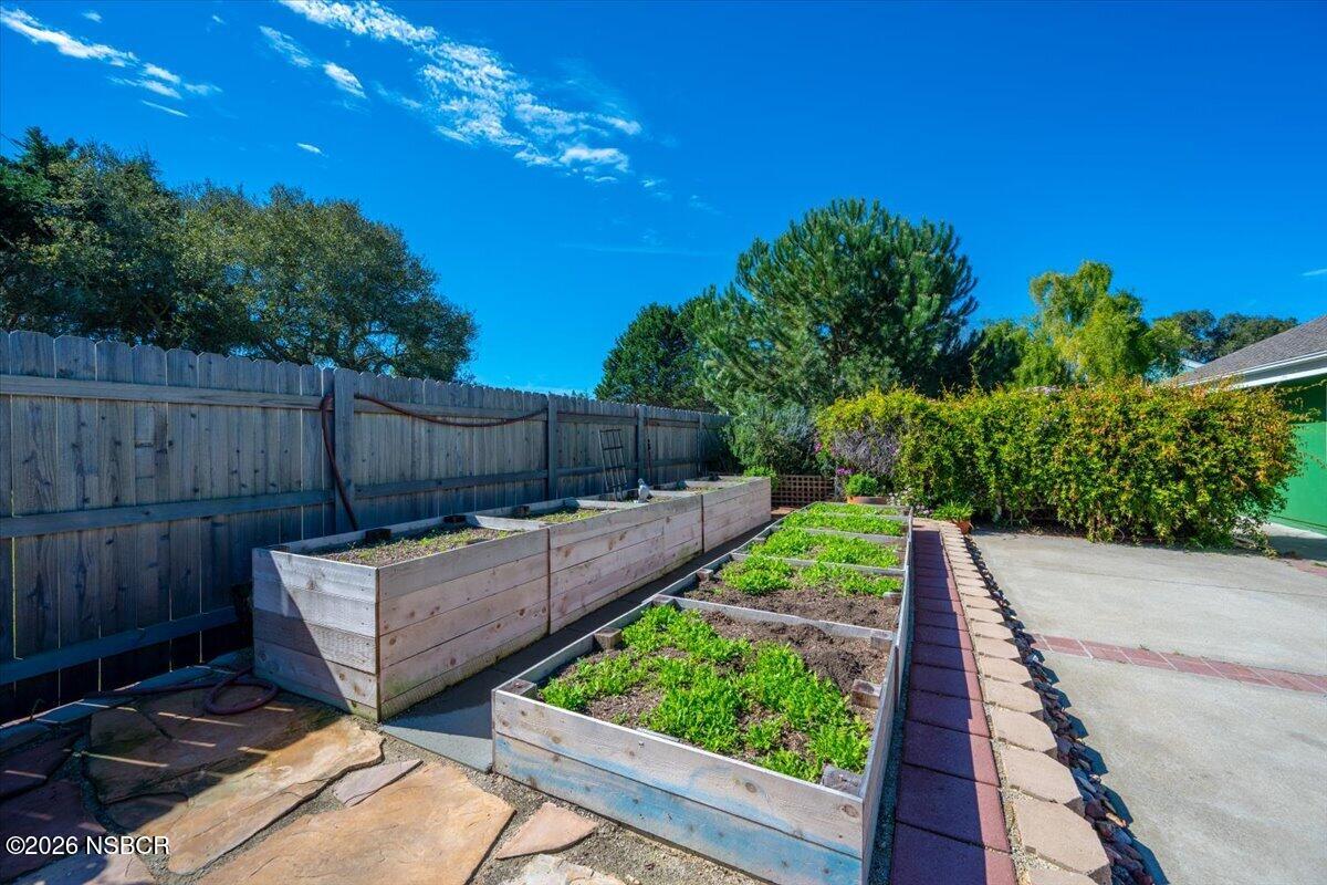 892 Onstott Road Lompoc, CA 93436 - Photo 33 of 40 a view of a backyard with couches plants and wooden fence