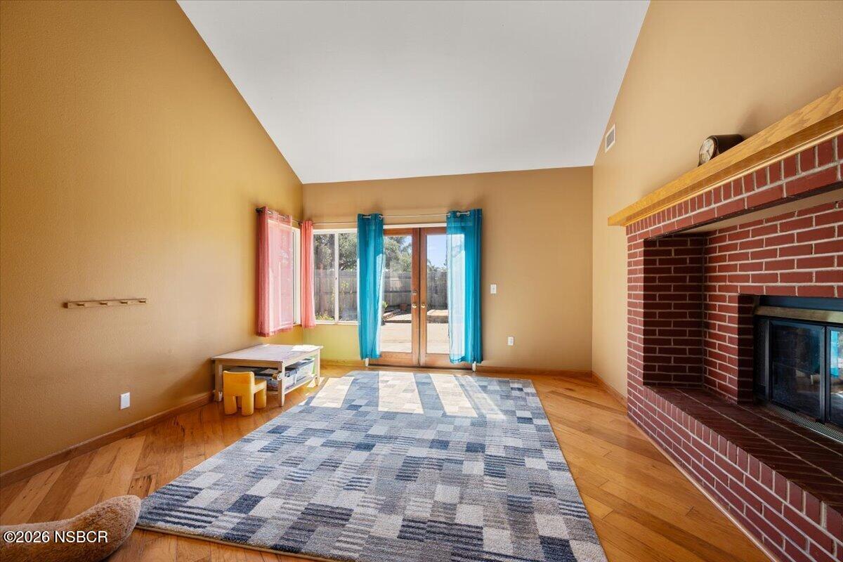 892 Onstott Road Lompoc, CA 93436 - Photo 8 of 40 a view of a livingroom with wooden floor and a fireplace