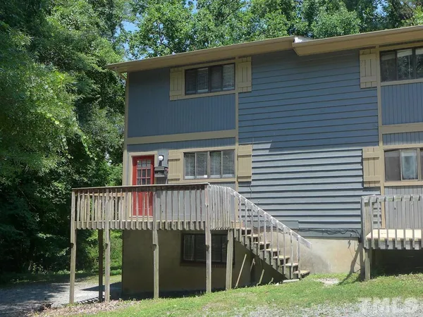 a view of house with a yard and furniture