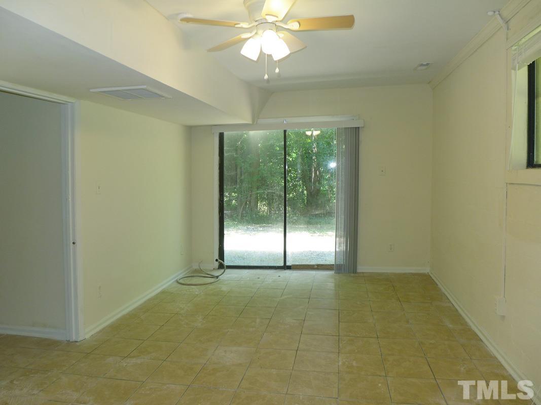 138 Johnson Street, Unit A Chapel Hill, NC 27516 - Photo 15 of 20 a view of an empty room with window and chandelier fan