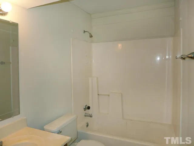 a bathroom with a shower and a toilet