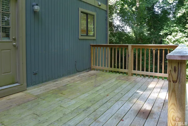 a view of backyard with deck and wooden floor
