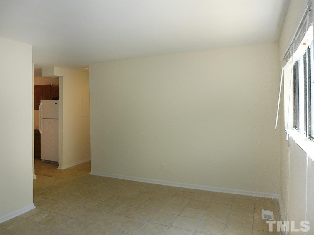138 Johnson Street, Unit A Chapel Hill, NC 27516 - Photo 4 of 20 an empty room with windows