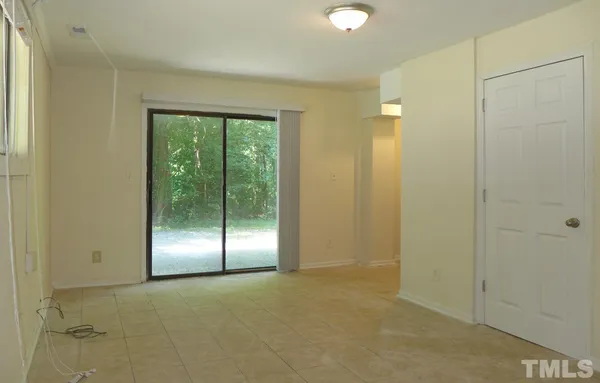 a view of an empty room with glass door