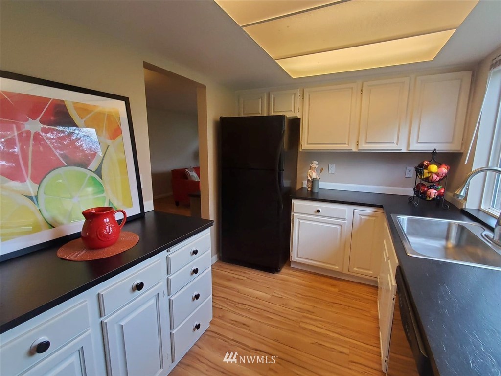 17036 138th Place Southeast Renton, WA 98058 - Photo 14 of 36 a kitchen with stainless steel appliances granite countertop a refrigerator and a sink