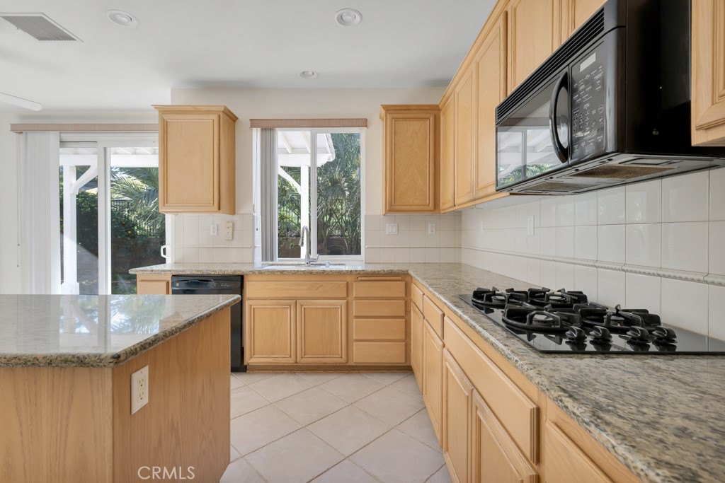 11205 Salerno Porter Ranch Porter Ranch, CA 91326 - Photo 13 of 43 a kitchen with sink a stove and cabinets