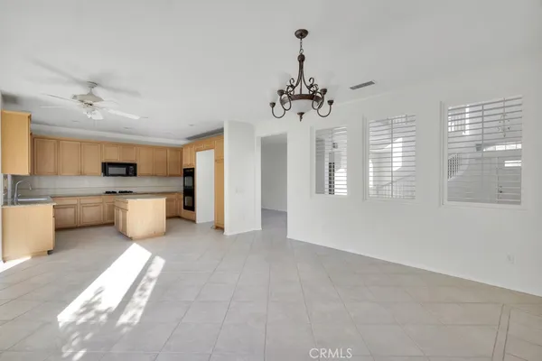 a view of a kitchen with a sink dishwasher a refrigerator and a large window