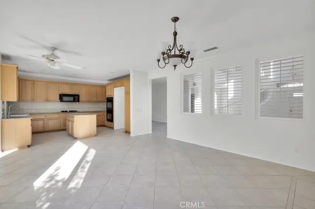 a view of a kitchen with a sink dishwasher a refrigerator and a large window