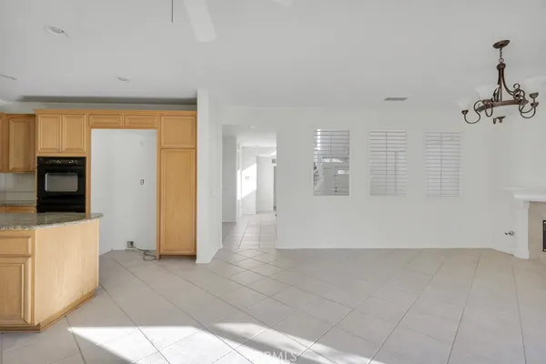 a view of a hallway with wooden floor and cabinet