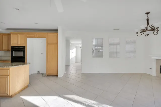 a view of a hallway with wooden floor and cabinet