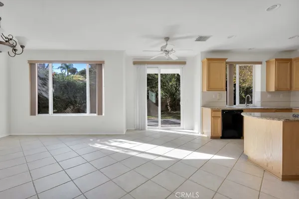 a view of an empty room with a kitchen