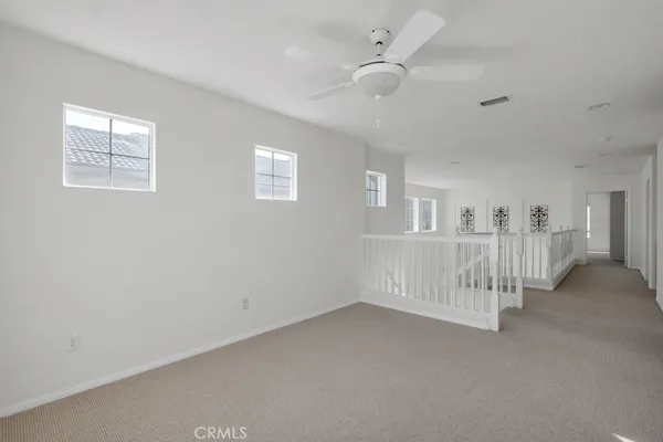 a view of an empty room with white walls