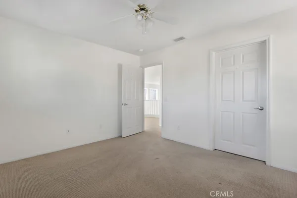 a view of a room with a ceiling fan