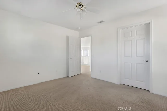 a view of a room with a ceiling fan