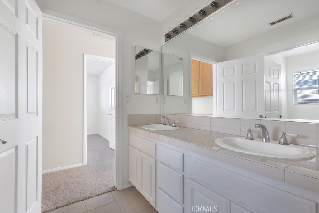 11205 Salerno Porter Ranch Porter Ranch, CA 91326 - Photo 32 of 43 a bathroom with a sink and a mirror