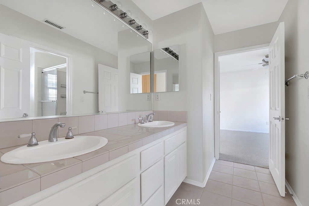11205 Salerno Porter Ranch Porter Ranch, CA 91326 - Photo 33 of 43 a bathroom with a sink and a mirror
