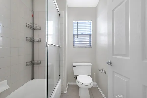a white toilet sitting next to a bath tub