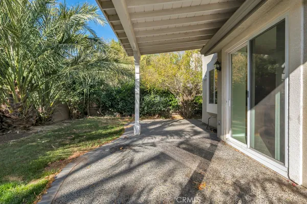a view of a house with backyard and porch