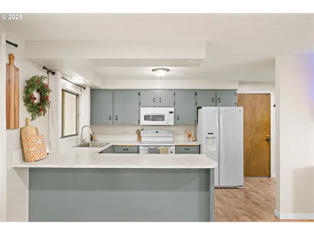 a bathroom with a sink a mirror and a refrigerator
