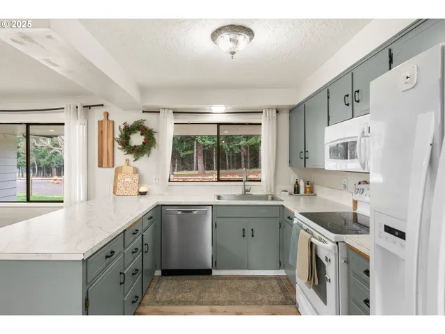 a kitchen with a sink stove and refrigerator