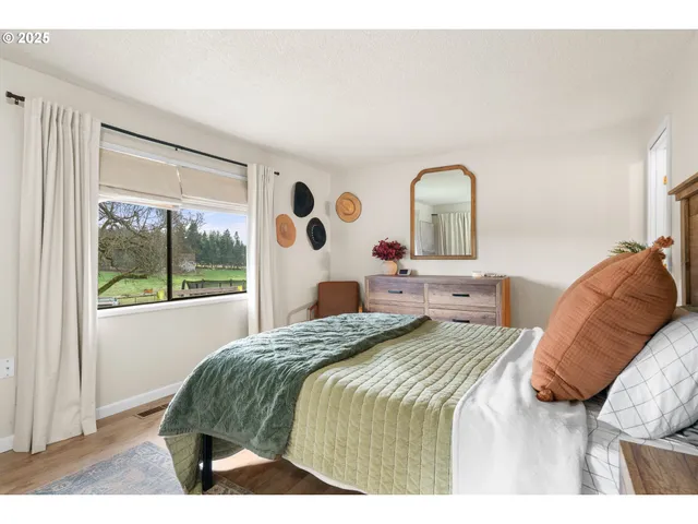 a bedroom with a bed and a large window