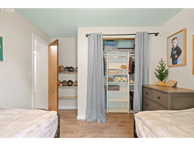 a room with a bed and a dresser