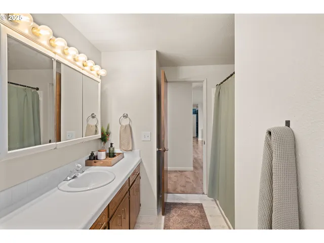 a bathroom with a sink vanity and a mirror